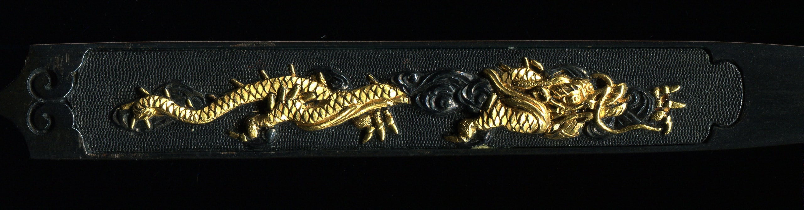 Beautiful shakudo kogai with a well carved design of dragon in the clouds.